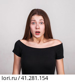 Close up portrait of a young beautiful girl isolated on gray background. Стоковое фото, фотограф Андрей Аркуша / Фотобанк Лори