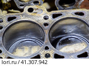 The cylinder block of the four-cylinder engine. Disassembled motor vehicle for repair. Parts in engine oil. Car engine repair in the service. Стоковое фото, фотограф Леонид Еремейчук / Фотобанк Лори