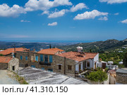 Photo of valley on Cyprus. View to the Mediterranean Sea from the hill where village Lefkara is. Cozy houses with blue shuttered windows, red tiled roofs and white water tanks on them at the front. Фотография долины на Кипре. Вид на Средиземное море с холма, на котором находится деревня Лефкара. Уютные домики с синими ставнями на окнах, красными черепичными крышами и белыми резервуарами для воды на фасаде (2019 год). Стоковое фото, фотограф Дмитрий Березнев / Фотобанк Лори