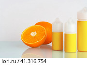 Vape liquid with orange flavor on white background. Стоковое фото, фотограф Сергей Толмачёв / Фотобанк Лори