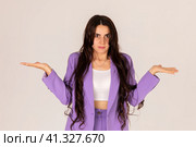 No idea. Unaware careless young beautiful caucasian confused woman wearing fashionable business outfit with open arms, no idea and doubtful face. I don't know concept. Стоковое фото, фотограф Ирина Михайличенко / Фотобанк Лори