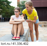 Girl asks girlfriend for forgiveness. Girl is unhappy upset there is no reluctance to talk. Стоковое фото, фотограф Яков Филимонов / Фотобанк Лори
