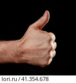 Male hand with a thumb up on a black background. Стоковое фото, фотограф Роман Сибиряков / Фотобанк Лори