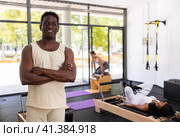 Positive African American man posing in fitness studio. Стоковое фото, фотограф Яков Филимонов / Фотобанк Лори