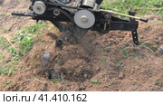 Powerful cultivator, Tiller. Gardening. Spring work on the farm. Land cultivation with a Motor ripper. Man plows the ground. Spring soil preparation for seeding. Husbandman, grower. Moto plow working. Стоковое видео, видеограф Марина Демидюк / Фотобанк Лори