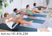 Boy perform boat asana - Paripurna navasana. Comprehensive hatha yoga class in mini group. Стоковое фото, фотограф Яков Филимонов / Фотобанк Лори