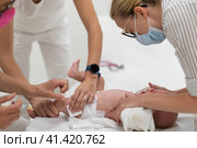 Baby beeing vaccinated by pediatrician in presence of his mother. Preventive vaccination against Diphtheria, whooping cough, tetanus, hepatitis, haemophilus influenzae, pneumococcus, poliomyelitis. Стоковое фото, фотограф Matej Kastelic / Фотобанк Лори