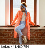 African model woman in orange spring jacket and blue pants. Стоковое фото, фотограф Андрей Аркуша / Фотобанк Лори