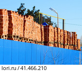 Red bricks stacked into cubes. Warehouse bricks. Storage brickworks products. Стоковое фото, фотограф Леонид Еремейчук / Фотобанк Лори
