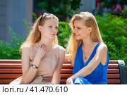 Two young beautiful women secret at summer green park. Стоковое фото, фотограф Андрей Аркуша / Фотобанк Лори