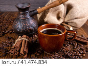 Ceramic brown cup and with black coffee and grains on wooden background still life. Стоковое фото, фотограф Александр Калугин / Фотобанк Лори