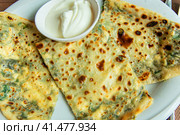 Delicious gourmet flat bread kutabs with herbs and cheese on a plate. Стоковое фото, фотограф Евгений Ткачёв / Фотобанк Лори