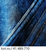 Stitching of a seam on denim clothes in close-up. Generated by AI. Стоковое AI-изображение, AI-художник Ярославский Максим / Фотобанк Лори