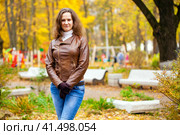 Young happy woman in brown leather jacket. Стоковое фото, фотограф Андрей Аркуша / Фотобанк Лори