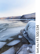 Baikal Lake in December. View of freezing Olkhon Gate Strait, transparent thin ice near shore and coastal rocks covered with crust of ice on cold day. Scenic seasonal landscape. Natural background. Winter trip. Стоковое фото, фотограф Виктория Катьянова / Фотобанк Лори