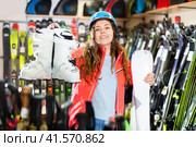 Smiling young girl chose skis, shelm and boots. Стоковое фото, фотограф Яков Филимонов / Фотобанк Лори