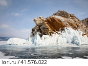 Baikal Lake on frosty day in February. View from ice to icy rocky islet in Small Sea. Scenic winter landscape. Natural background. Ice travel and outdoor recreation. Стоковое фото, фотограф Виктория Катьянова / Фотобанк Лори