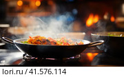 Two woks on a stove with food in them, AI. Стоковое AI-изображение, AI-художник Сергей Старуш / Фотобанк Лори