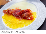 Delicious serving of pineapple and melon carpaccio with thinly sliced prosciutto. Стоковое фото, фотограф Яков Филимонов / Фотобанк Лори