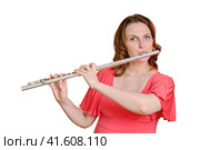 Portrait of a woman musician with a flute on a studio isolated white background. Flutist with a large concert transverse flute in her hands. Стоковое фото, фотограф Андрей Журавлев / Фотобанк Лори