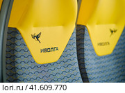 Yellow seats in the train. Transportation of passengers on the Ivolga train - Moscow, Russia August 30, 2023. Редакционное фото, фотограф Андрей Журавлев / Фотобанк Лори