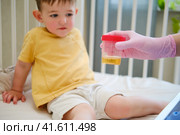 The pediatric nurse recommended taking a urine sample from the child for analysis when the doctor suspected a potential health issue. Kid aged about two years (one year eleven months) Стоковое фото, фотограф Андрей Журавлев / Фотобанк Лори