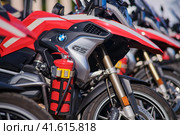 Close-up of a red fire extinguisher on a fire fighting motorcycle BMW G5 - Moscow, Russia, 05 September 2023. Редакционное фото, фотограф Андрей Журавлев / Фотобанк Лори