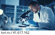 Microbiologist scientist looking through a microscope. Стоковое AI-изображение, AI-художник Кирилл Черезов / Фотобанк Лори