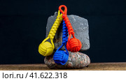Braided paracord keychain on a background of stones. Handmade, creative design. Стоковое фото, фотограф Артем Лукин / Фотобанк Лори