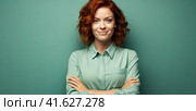 A young teenage girl looks straight into the camera with a solid light green background. The concept of the beauty of youth. Generated by artificial intelligence. Стоковое AI-изображение, AI-художник Ярославский Максим / Фотобанк Лори