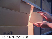 Male hands in a warehouse with box, night theft. Стоковое фото, фотограф Андрей Журавлев / Фотобанк Лори