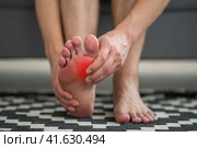 Foot pain, man suffering from feet ache at home. Стоковое фото, фотограф Станислав Тарко / Фотобанк Лори