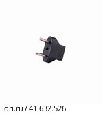 2-pin EU to US plug type Converter black Plastic element isolated on a white background. Close up. Стоковое фото, фотограф Воловодов Владимир / Фотобанк Лори