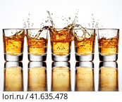 Glasses with yellow liquid on a white background with splashes. Generated by AI. Стоковое AI-изображение, AI-художник Ярославский Максим / Фотобанк Лори
