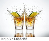 Glasses with yellow liquid on a white background with splashes. Generated by AI. Стоковое AI-изображение, AI-художник Ярославский Максим / Фотобанк Лори