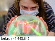 A fortuneteller predicts the future of coronavirus disease after 2020. Vaccine problems and predicting the fate of the virus on the magic ball. Стоковое фото, фотограф Андрей Журавлев / Фотобанк Лори