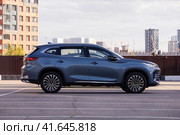 EXEED TXL SUV car parked on the street with urban background. Редакционное фото, фотограф Константин Григорьев / Фотобанк Лори