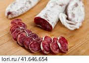 Spanish sausage fuet on a wooden table, closeup. Стоковое фото, фотограф Яков Филимонов / Фотобанк Лори