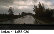 Extreme Driving during heavy downpour storm. Selective focus. POV of car windscreen. Dangerous wet asphalt road trip. Bad visibility. Moving windshield wiper vehicle. Traffic at Rainfall. Travel blog. Стоковое видео, видеограф Марина Демидюк / Фотобанк Лори