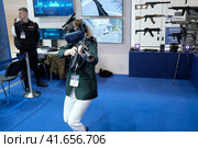 Training of female police and soldiers using a virtual reality helmet at exhibition Interpolitex - Moscow, Russia, 10 25 2019. Редакционное фото, фотограф Андрей Журавлев / Фотобанк Лори