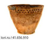Old clay vase from the Neolithic period, isolated. The oldest pottery in the world belongs to the Osipov culture. Discovered by archaeologists in the far East, Russia (2019 год). Редакционное фото, фотограф Андрей Журавлев / Фотобанк Лори