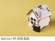 Housing arrest. Castle house. Small toy house and a chain with a lock. Стоковое фото, фотограф Алексей Круковский / Фотобанк Лори