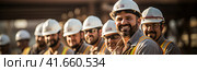 A confident and smiling staff of factory workers, engineers, managers and foremen stands on the territory of the heavy industry production plant. Generated by AI. Стоковое AI-изображение, AI-художник Ярославский Максим / Фотобанк Лори