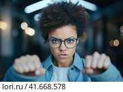 A woman in a state of extreme rage, with clenched fists and jaw, angry, emotional and furious, is singled out for office. Generated by AI. Стоковое AI-изображение, AI-художник Ярославский Максим / Фотобанк Лори