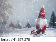 A Christmas gnome on a sled in the snow. New Year's, Christmas background. Стоковое фото, фотограф Ольга Ильина / Фотобанк Лори