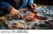 Geographer exploring the terrain on the model. Стоковое AI-изображение, AI-художник Кирилл Черезов / Фотобанк Лори