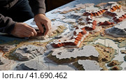 Geographer exploring the terrain on the model. Стоковое AI-изображение, AI-художник Кирилл Черезов / Фотобанк Лори