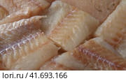 Raw fish fillet is spinning. Top view. Slices of fresh whitefish. Full frame. Sashimi rotation. Close up. Marine market. Video for sale. Cod, pollock loin steaks. Pangasius, tilapia pieces background. Стоковое видео, видеограф Марина Демидюк / Фотобанк Лори