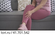 Leg pain, woman suffering from ache and doing self-massage at home, self-soothing massaging. Стоковое видео, видеограф Станислав Тарко / Фотобанк Лори