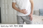 Stomach ache, man with abdominal pain suffering at home, health problems concept. Стоковое видео, видеограф Станислав Тарко / Фотобанк Лори